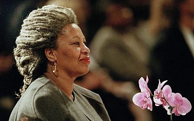 In this April 5, 1994 file photo, Toni Morrison holds an orchid at the Cathedral of St. John the Divine in New York. (AP Photo/Kathy Willens, File)