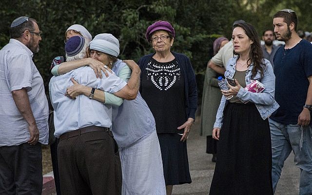 Relatives, friends and other mourners attend the funeral of Dvir Sorek, 18, at his hometown settlement of Ofra, Thursday, Aug. 8, 2019. Sorek was stabbed to death hours earlier in a terrorist attack in the West Bank south of Jerusalem. (AP Photo/Tsafrir Abayov)