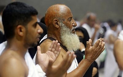 Muslim pilgrims pray after they cast stones at a pillar symbolizing the stoning of Satan, in a ritual called "Jamarat," the last rite of the annual hajj, on the first day of Eid al-Adha, in Mina near the holy city of Mecca, Saudi Arabia, Sunday, Aug. 11, 2019. (AP Photo/Amr Nabil)