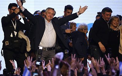 Presidential candidate Alberto Fernandez addresses supporters at the "Frente de Todos" party headquarters after primary elections in Buenos Aires, Argentina, Sunday, Aug. 11, 2019. The "Frente de Todos" presidential ticket with former President Cristina Fernández emerged as the strongest vote-getter in Argentina’s primary elections Sunday, indicating conservative President Mauricio Macri will face an uphill battle going into general elections in October. (AP Photo/Sebastian Pani)