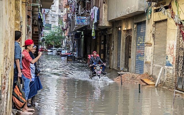 A motorcyclist rides through floodwater in the coastal city of Alexandria, Egypt. Alexandria, October 25, 2015. (Heba Khamis/AP)