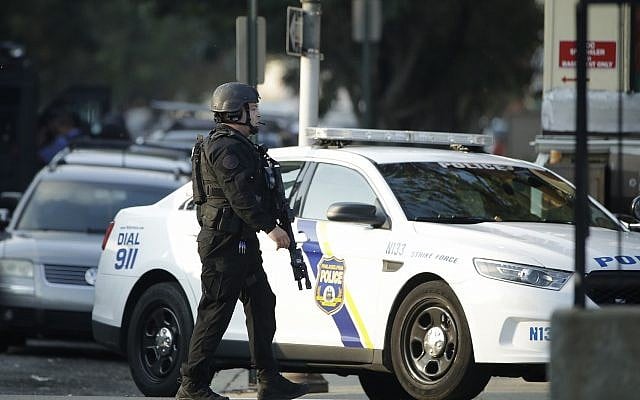 A police officer patrols the block near a house as during an active shooting situation, Wednesday, Aug. 14, 2019, in the Nicetown neighborhood of Philadelphia. (AP Photo/Matt Rourke) A police officer patrols the block near a house as during an active shooting situation, Wednesday, Aug. 14, 2019, in the Nicetown neighborhood of Philadelphia. (AP Photo/Matt Rourke)
