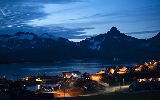 In this photo taken late Friday, Aug. 16, 2019, homes are illuminated after the sunset in Tasiilaq, Greenland. (AP Photo/Felipe Dana) In this photo taken late Friday, Aug. 16, 2019, homes are illuminated after the sunset in Tasiilaq, Greenland. (AP Photo/Felipe Dana)