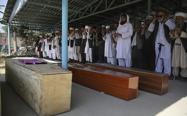 Afghans pray near the coffins of victims of the Dubai City wedding hall bombing during a mass funeral in Kabul, Afghanistan, August 18, 2019. (Rafiq Maqbool/AP) Afghans pray near the coffins of victims of the Dubai City wedding hall bombing during a mass funeral in Kabul, Afghanistan, August 18, 2019. (Rafiq Maqbool/AP)