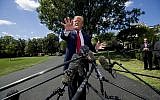 US President Donald Trump speaks with reporters before departing on Marine One on the South Lawn of the White House, August 21, 2019, in Washington. (AP Photo/Alex Brandon)