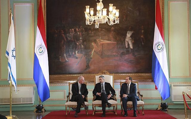President Mario Abdo Benitez, center, talks to Israel's new ambassador to Paraguay, Yoed Magen, left, as Foreign Minister Antonio Rivas Palacios, right, listens, during official ceremony, at Lopez Palace, Asuncion, Paraguay, August 21, 2019. (Anibal Ovelar/Paraguay's Government Press Office via AP) President Mario Abdo Benitez, center, talks to Israel's new ambassador to Paraguay, Yoed Magen, left, as Foreign Minister Antonio Rivas Palacios, right, listens, during official ceremony, at Lopez Palace, Asuncion, Paraguay, August 21, 2019. (Anibal Ovelar/Paraguay's Government Press Office via AP)
