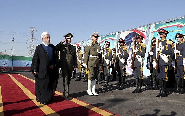 In this photo released by the official website of the office of the Iranian Presidency, President Hassan Rouhani, left, reviews an honor guard as he is accompanied by his Defense Minister Gen. Amir Hatami during a ceremony to unveil Iran-made Bavar-373 air-defense missile system, Iran, Thursday, Aug. 22, 2019. (Iranian Presidency Office via AP) In this photo released by the official website of the office of the Iranian Presidency, President Hassan Rouhani, left, reviews an honor guard as he is accompanied by his Defense Minister Gen. Amir Hatami during a ceremony to unveil Iran-made Bavar-373 air-defense missile system, Iran, Thursday, Aug. 22, 2019. (Iranian Presidency Office via AP)