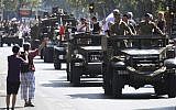 People dressed in World War II era clothes take part in the celebrations of the liberation of Paris from Nazi occupation 75 years ago, in Paris, August 25, 2019. (AP Photo/David Vincent)