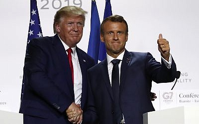 US President Donald Trump and French President Emmanuel Macron shake hands after their joint press conference at the G7 summit on August 26, 2019 in Biarritz, southwestern France. (AP Photo/Francois Mori)