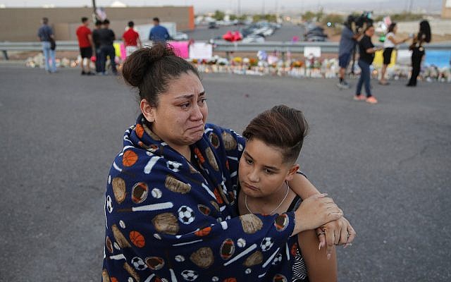 In this August 5, 2019, file photo, Clarissa Hernandez holds Ezra Magallanes as they speak with the media at a makeshift memorial for victims of a mass shooting at a shopping complex in El Paso, Texas. (AP Photo/John Locher, File) In this August 5, 2019, file photo, Clarissa Hernandez holds Ezra Magallanes as they speak with the media at a makeshift memorial for victims of a mass shooting at a shopping complex in El Paso, Texas. (AP Photo/John Locher, File)