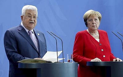 German Chancellor Angela Merkel, right, and Palestinian Authority President Mahmoud Abbas, left, address the media during a joint statement prior to a meeting at the Chancellery in Berlin, Germany, August 29, 2019. (AP Photo/Michael Sohn)