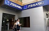 People walk past a branch of Jammal Trust Bank in Beirut, Lebanon, August 30, 2019. (AP Photo/Bilal Hussein)