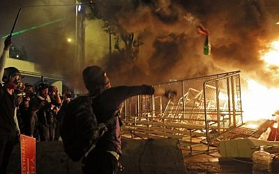 A protestor throws a molotov cocktail towards a barrier in Hong Kong on August 31, 2019. (AP Photo/Kin Cheung)