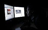 Illustrative: A Saudi man looking at Facebook at his Riyadh office on Thursday, Feb. 10, 2011. (AP/Hassan Ammar)