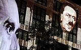 The faces of Adolf Hitler, right, and Joseph Goebbels, left, are projected onto 3D canvases as part of an art installation during a rehearsal for the 'Berlin Leuchtet' (Berlin shines) festival in Berlin, Germany, September 29, 2016. (AP Photo/Michael Sohn)