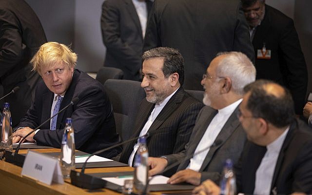 Then-British Foreign Secretary Boris Johnson, left, looks at Iranian Foreign Minister Javad Zarif, second right, during a meeting of the foreign ministers from Britain, France and Germany at the Europa building in Brussels, on May 15, 2018. (AP Photo/Olivier Matthys, Pool) Then-British Foreign Secretary Boris Johnson, left, looks at Iranian Foreign Minister Javad Zarif, second right, during a meeting of the foreign ministers from Britain, France and Germany at the Europa building in Brussels, on May 15, 2018. (AP Photo/Olivier Matthys, Pool)