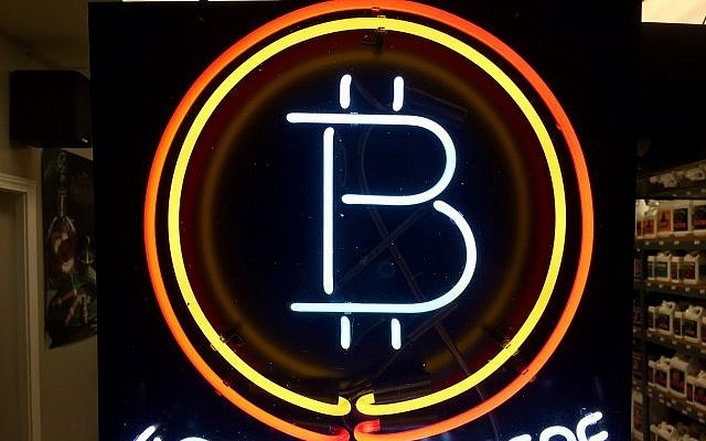 FILE - In this Feb. 7, 2018 file photo, a neon sign hanging in the window of Healthy Harvest Indoor Gardening in Hillsboro, Oregon, shows that the business accepts bitcoin as payment. (AP Photo/Gillian Flaccus, File) FILE - In this Feb. 7, 2018 file photo, a neon sign hanging in the window of Healthy Harvest Indoor Gardening in Hillsboro, Oregon, shows that the business accepts bitcoin as payment. (AP Photo/Gillian Flaccus, File)