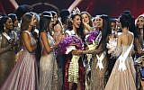 Contestants congratulate new Miss Universe Catriona Gray, center, from the Philippines during the final round of the 67th Miss Universe competition in Bangkok, Thailand on December 17, 2018.(AP/Gemunu Amarasinghe)