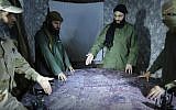 Illustrative: This undated file photo released in 2016, shows Abu Mohammed al-Golani of the Levant Liberation Committee and the leader of Syria's al-Qaida affiliate, second right, discussing battlefield details with field commanders over a map, in Aleppo, Syria.  (Militant UGC via AP, File)