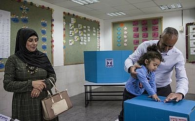 A family votes during elections in a predominantly Bedouin city of Rahat on April 9, 2019. (AP/Tsafrir Abayov)