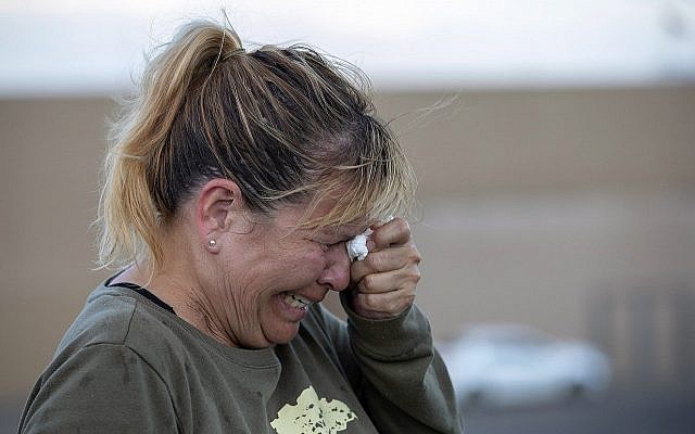 Edie Hallberg cries while speaking to police outside a Walmart store where a shooting occurred earlier in the day as she looks for her missing mother Angie Englisbee, who was in the store during the attack in El Paso, Texas, Aug. 3, 2019 (AP Photo/Andres Leighton)
