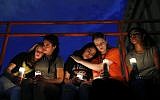 From left, Melody Stout, Hannah Payan, Aaliyah Alba, Sherie Gramlich and Laura Barrios comfort each other during a vigil for victims of the shooting August  3, 2019, in El Paso, Texas. (AP Photo/John Locher)