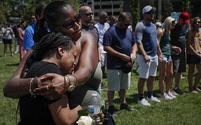 Mourners gather at a vigil following a nearby mass shooting, Aug. 4, 2019, in Dayton, Ohio (AP Photo/John Minchillo)