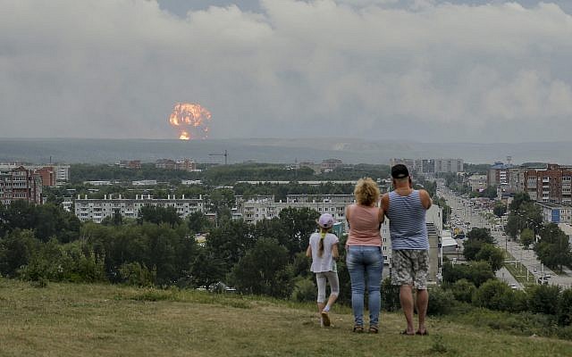 A family watches explosions at a military ammunition depot near the city of Achinsk, Russia on Aug. 5, 2019. (AP Photo/Dmitry Dub) A family watches explosions at a military ammunition depot near the city of Achinsk, Russia on Aug. 5, 2019. (AP Photo/Dmitry Dub)