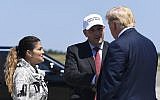 Former US President Donald Trump, right, greets Representative Lee Zeldin, center, and his wife Diana Zeldin, left, after arriving at Francis S. Gabreski Airport in Westhampton Beach, New York, August 9, 2019. (AP Photo/Susan Walsh)