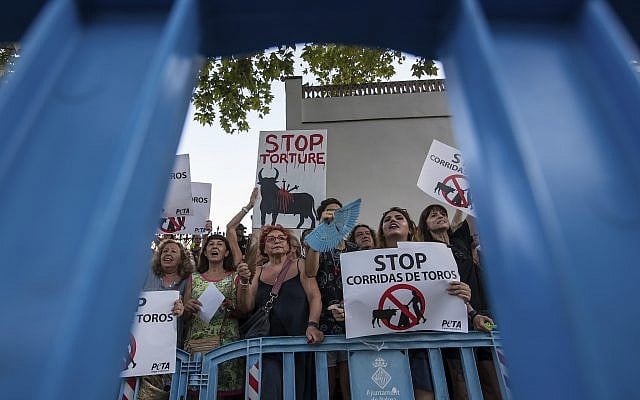 In this photo taken on Friday, Aug. 9, 2019, anti bullfighting protesters gather outside the Coliseo Balear bullring before a bullfight in Palma de Mallorca, Spain. The bullfight is the first in Mallorca since a court turned over a regional law on the island that made it very difficult to hold bull fights. (AP Photo/Atienza) In this photo taken on Friday, Aug. 9, 2019, anti bullfighting protesters gather outside the Coliseo Balear bullring before a bullfight in Palma de Mallorca, Spain. The bullfight is the first in Mallorca since a court turned over a regional law on the island that made it very difficult to hold bull fights. (AP Photo/Atienza)