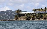 A view of Jeffrey Epstein's stone mansion on Little St. James Island, a property owned by Jeffrey Epstein, is backdropped by St. John Island, August 14, 2019. (AP Photo/Gabriel Lopez Albarran)