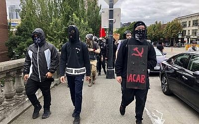 Anti-fascist counter-demonstrators cross the Burnside Bridge across the Willamette River from the west side of the city to the east side in search of the far-right group, the Proud Boys, in Portland, Ore., Saturday, Aug. 17, 2019. (AP Photo/Gillian Flaccus)
