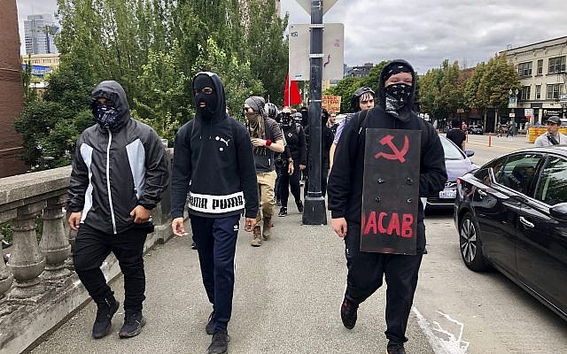 Anti-fascist counter-demonstrators cross the Burnside Bridge across the Willamette River from the west side of the city to the east side in search of the far-right group, the Proud Boys, in Portland, Ore., Saturday, Aug. 17, 2019. (AP Photo/Gillian Flaccus) Anti-fascist counter-demonstrators cross the Burnside Bridge across the Willamette River from the west side of the city to the east side in search of the far-right group, the Proud Boys, in Portland, Ore., Saturday, Aug. 17, 2019. (AP Photo/Gillian Flaccus)