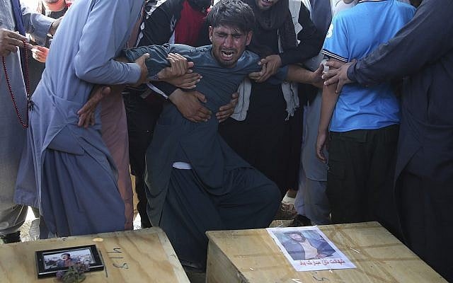 A relative wails near the coffins of victims of the Dubai City wedding hall bombing during a mass funeral in Kabul, Afghanistan, Sunday, Aug.18, 2019. (AP Photo/Rafiq Maqbool) A relative wails near the coffins of victims of the Dubai City wedding hall bombing during a mass funeral in Kabul, Afghanistan, Sunday, Aug.18, 2019. (AP Photo/Rafiq Maqbool)