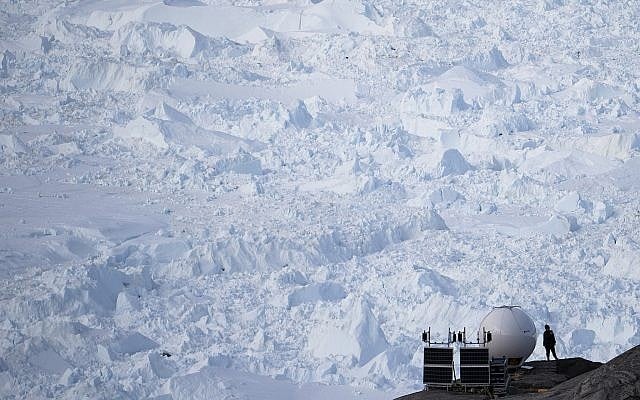 In this Aug. 16, 2019, photo, a woman stands next to an antenna at an NYU base camp at the Helheim glacier in Greenland. (AP Photo/Felipe Dana) In this Aug. 16, 2019, photo, a woman stands next to an antenna at an NYU base camp at the Helheim glacier in Greenland. (AP Photo/Felipe Dana)