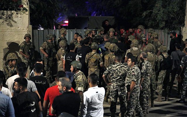 Lebanese security stand near the site where an Israeli drone was said to have crashed in a stronghold of the Lebanese Hezbollah group, in a southern suburb of Beirut, Lebanon, Sunday, August 25, 2019. (AP/Bilal Hussein) Lebanese security stand near the site where an Israeli drone was said to have crashed in a stronghold of the Lebanese Hezbollah group, in a southern suburb of Beirut, Lebanon, Sunday, August 25, 2019. (AP/Bilal Hussein)