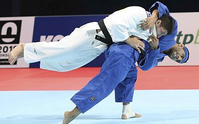 Judoka Luka Maisuradze of Georgia, top, competes against Saeid Mollaei of Iran during a men's under-81 kilogram bronze medal match at the World Judo Championships in Tokyo, August 28, 2019. (AP Photo/Koji Sasahara)