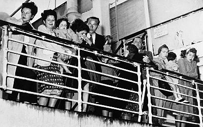 European refugees, denied entry to the United States in New York and Mexico at Veracruz, line the rail of the Portuguese steamer Quanza and talk to relatives on the pier when the ship stopped to refuel at Norfolk, Virginia, September 11, 1940. One passenger, a German, was captured by an army guard after diving overboard in Hampton Roads. (AP Photo)