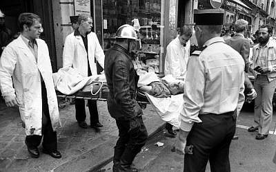 A police officer looks at an injured man being carried away on a stretcher from the scene of a terror attack at Jewish restaurant and deli Jo Goldenberg in Paris, France, on Aug. 9, 1982. The attack left six dead and many injured. (AP Photo/ Lionel Cironneau) A police officer looks at an injured man being carried away on a stretcher from the scene of a terror attack at Jewish restaurant and deli Jo Goldenberg in Paris, France, on Aug. 9, 1982. The attack left six dead and many injured. (AP Photo/ Lionel Cironneau)