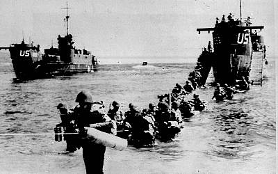Allied troops wade through the water from a landing ship on an unidentified beach, east of Toulon, southern French riviera, as part of Operation Dragoon, in this Aug 16, 1944, photo (AP Photo)