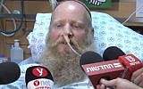 Rabbi Eitan Shnerb speaks to reporters from his hospital bed after being wounded in a terror attack that also killed his daughter Rina and wounded his son Dvir on August 23, 2019 (Screencapture/Ynet)