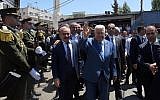 (L-R) Palestinian Authority Prime Minister Mahmoud Shtayyeh and President Mahmoud Abbas tour the Jalazone refugee camp in the West Bank on August 10, 2019. (Wafa)