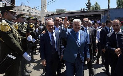 (L-R) Palestinian Authority Prime Minister Mahmoud Shtayyeh and President Mahmoud Abbas tour the Jalazone refugee camp in the West Bank on August 10, 2019. (Wafa)