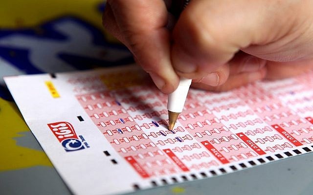 Illustrative. A person filling out a lottery ticket in Jerusalem on October 17, 2010. (Abir Sultan/Flash90/File) Illustrative. A person filling out a lottery ticket in Jerusalem on October 17, 2010. (Abir Sultan/Flash90/File)
