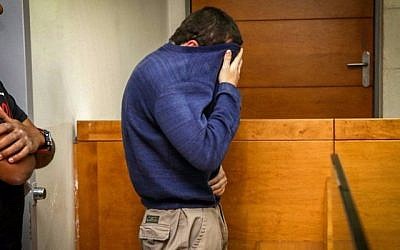 The suspect brought for a court hearing at the Rishon Lezion Magistrate’s Court, under suspicion of Issuing fake bomb threats against Jewish institutions around the world, on March 23, 2017. (Flash90)