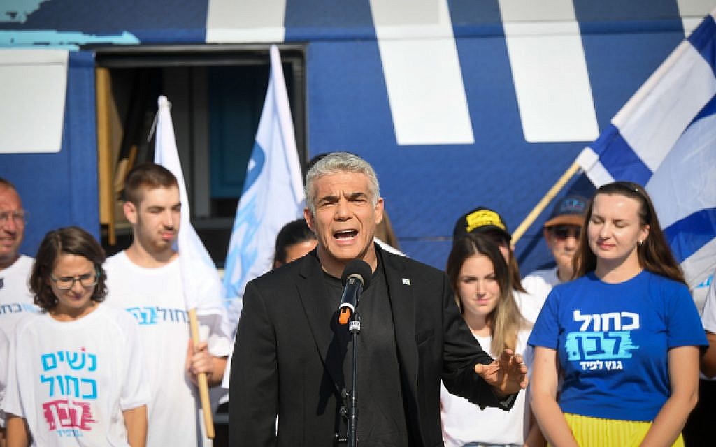 Yair Lapid and supporters of Blue and White Party pose outside their campaign bus in Glilot, July 21, 2019. (Flash90) Yair Lapid and supporters of Blue and White Party pose outside their campaign bus in Glilot, July 21, 2019. (Flash90)