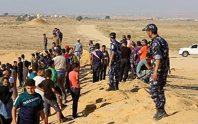 Palestinian security forces loyal to Hamas prevent demonstrators from getting closer to the border during a protest along the border with Israel, in Rafah in the southern Gaza Strip on August 2, 2019. (Abed Rahim Khatib/Flash90)