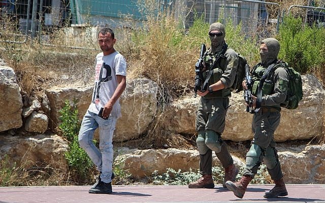 Israeli soldiers are seen near the West Bank settlement of Migdal Oz, on August 8, 2019, after seminary student Dvir Sorek was found stabbed to death outside the settlement. (Gershon Elinson/Flash90) Israeli soldiers are seen near the West Bank settlement of Migdal Oz, on August 8, 2019, after seminary student Dvir Sorek was found stabbed to death outside the settlement. (Gershon Elinson/Flash90)