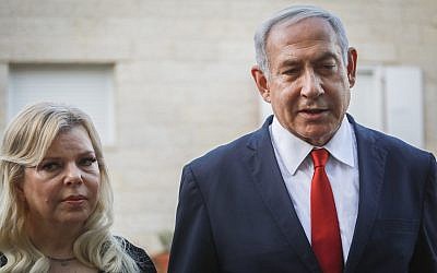 Prime Minister Benjamin Netayahu and his wife Sara speak with the media outside the Sorek family home, in Ofra, in the West Bank on August 13, 2019. (Flash90)