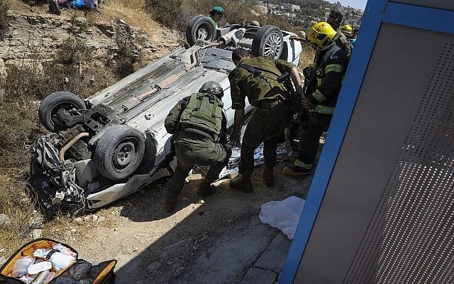 Soldiers inspect a car used in a ramming attack outside the West Bank settlement of Elazar on August 16, 2019 (Gershon Elinson/Flash90) Soldiers inspect a car used in a ramming attack outside the West Bank settlement of Elazar on August 16, 2019 (Gershon Elinson/Flash90)